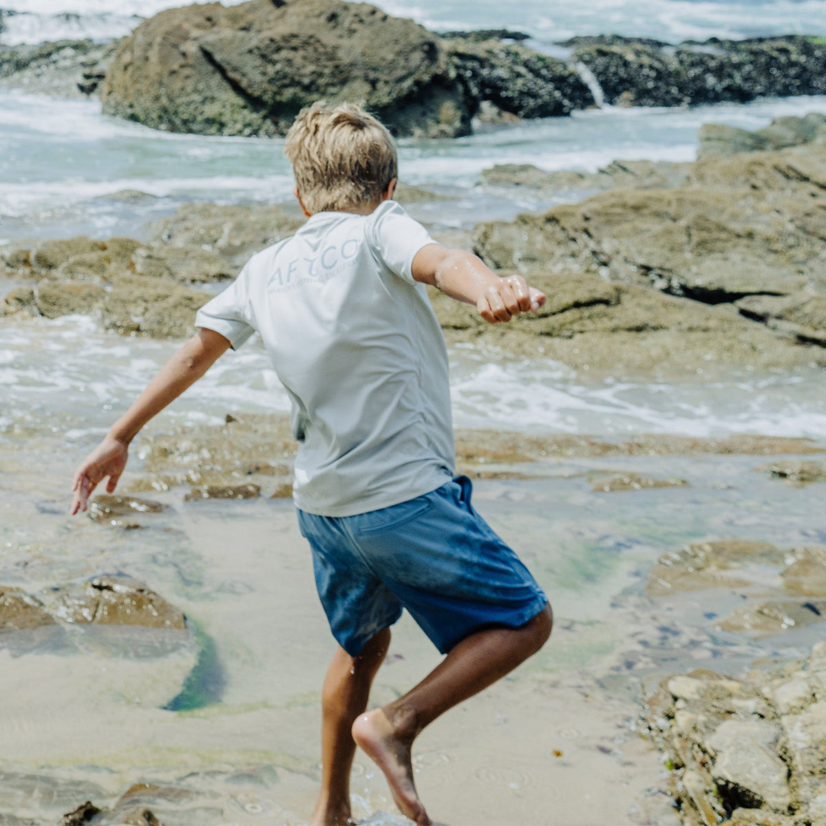 Coral Youth Strike Printed Swim Shorts / AFTCO Featured